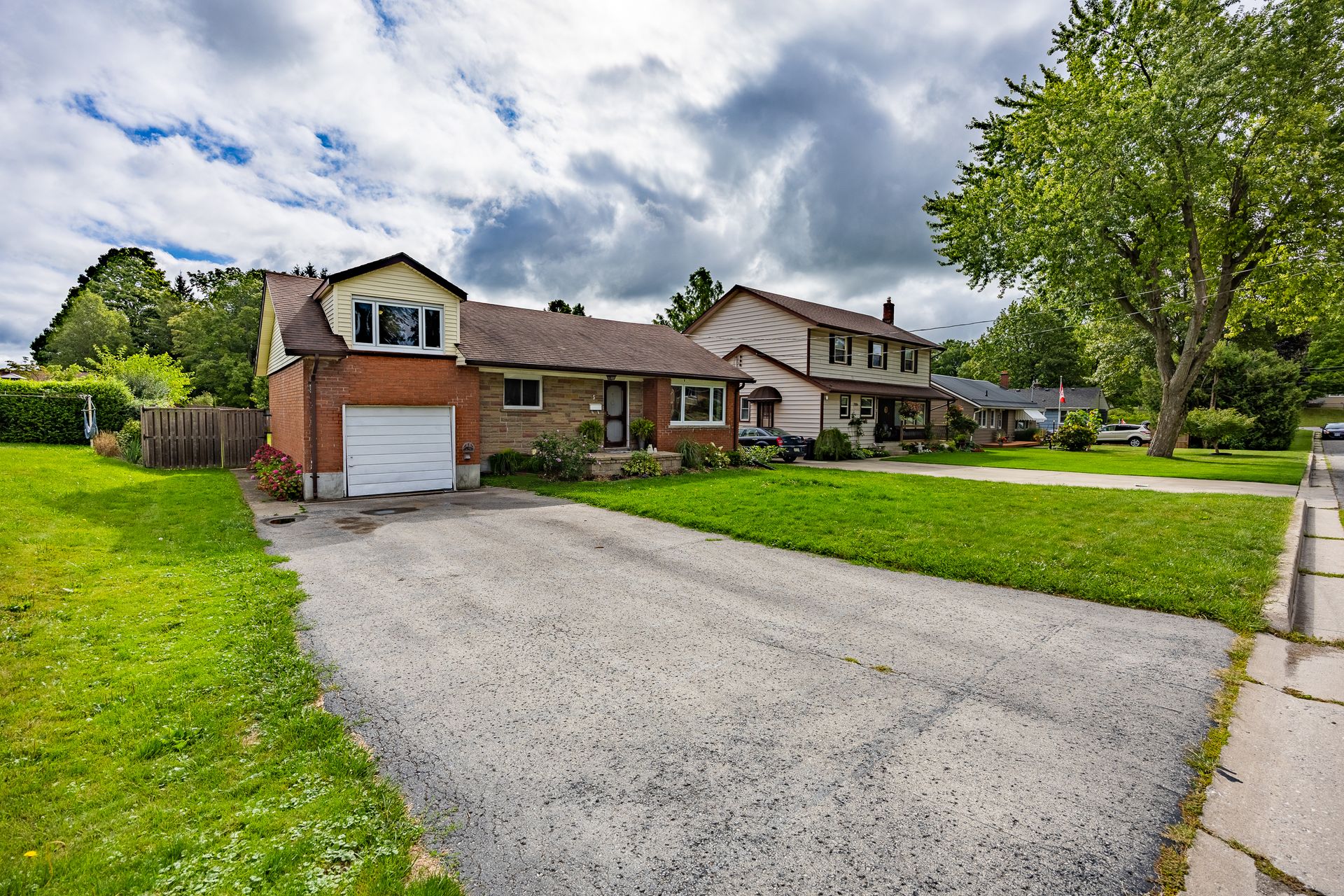Front view of home, featuring asphalt driveway, brick siding, and a garage at 5 Bint Avenue, Simcoe Front view of home, featuring asphalt driveway, brick siding, and a garage at 5 Bint Avenue, Simcoe