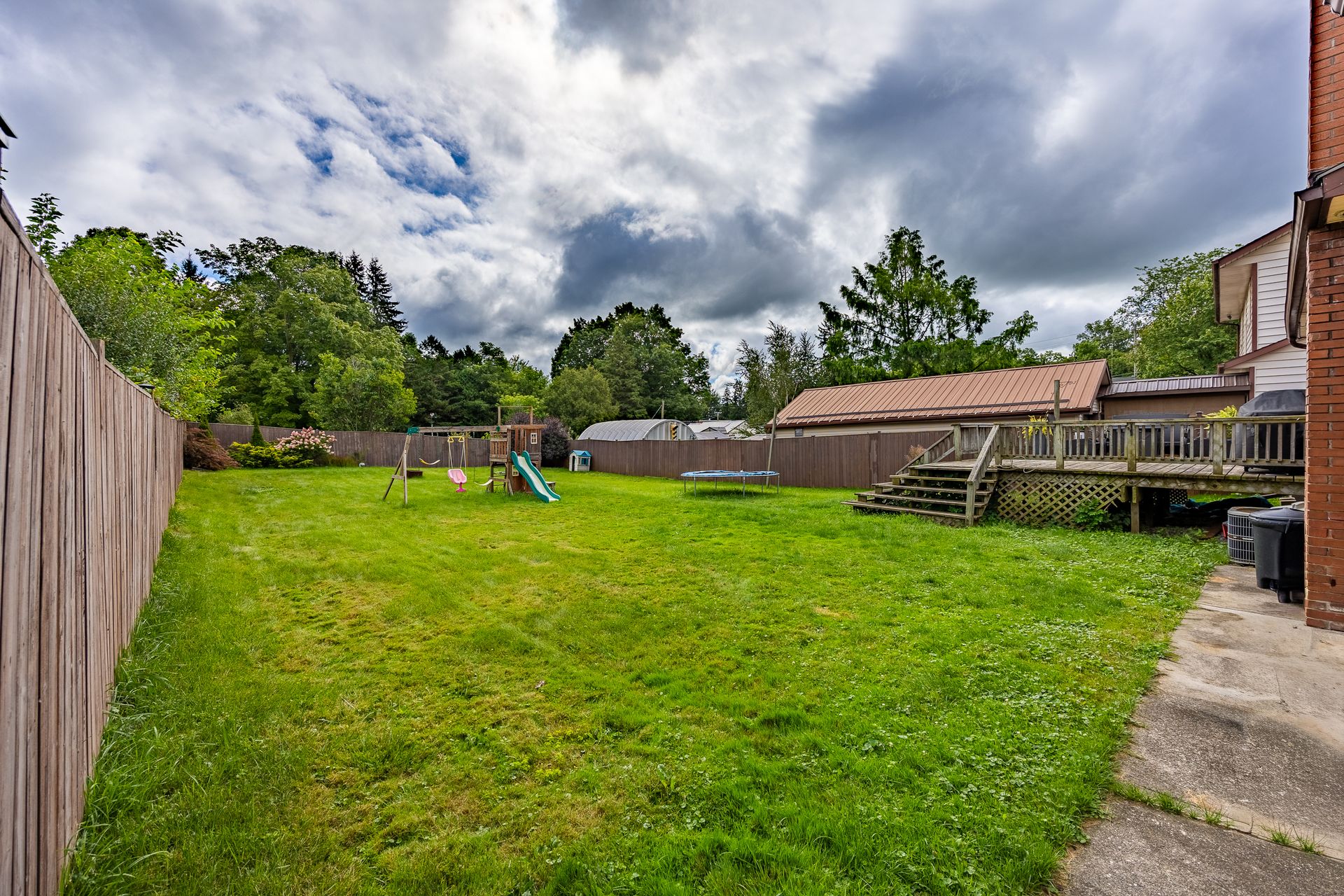 Fully fenced backyard with a wooden deck at 5 Bint Avenue, Simcoe Fully fenced backyard with a wooden deck at 5 Bint Avenue, Simcoe