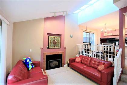 Living room with fireplace at 8503 Timber Court, Burnaby North