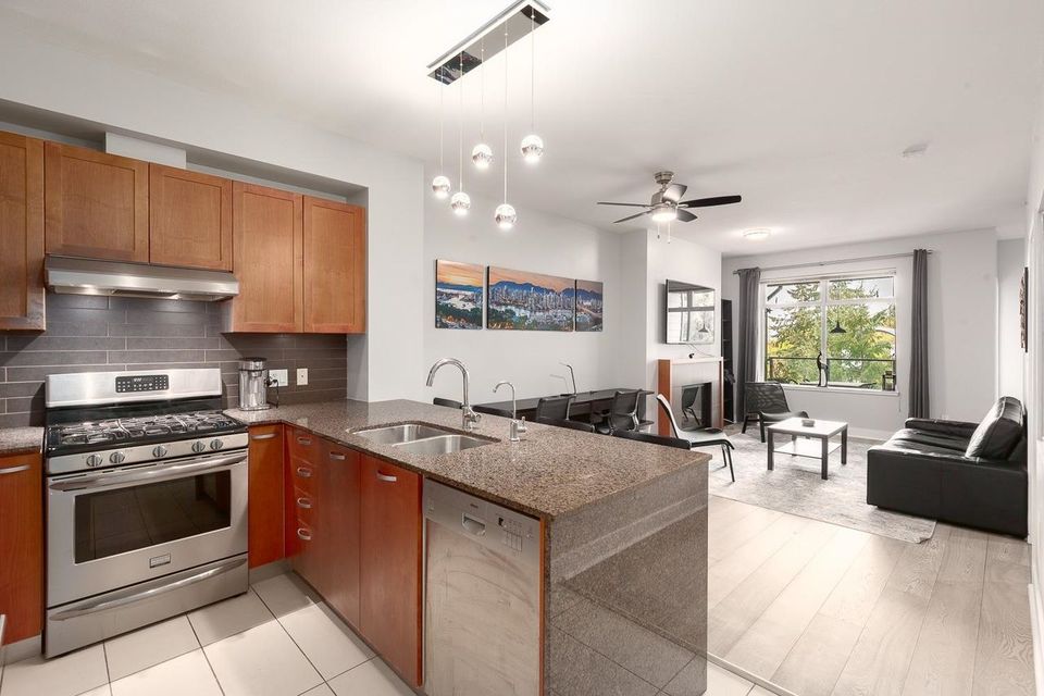 Open kitchen with a breakfast bar at 406 - 5955 Iona Drive, University VW, Vancouver West