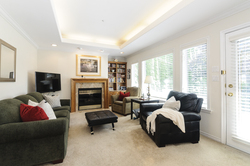 Family room with gas fireplace that opens to the back deck at 1178 West 42nd Avenue, South Granville, Vancouver West