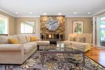 Formal Living Room with Gas fireplace and French doors opening to backyard at 3955 Viewridge Place, Bayridge, West Vancouver