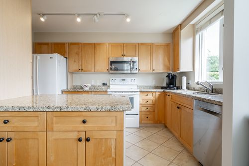 Kitchen from the dining room at 301 - 2203 Bellevue Avenue, Dundarave, West Vancouver