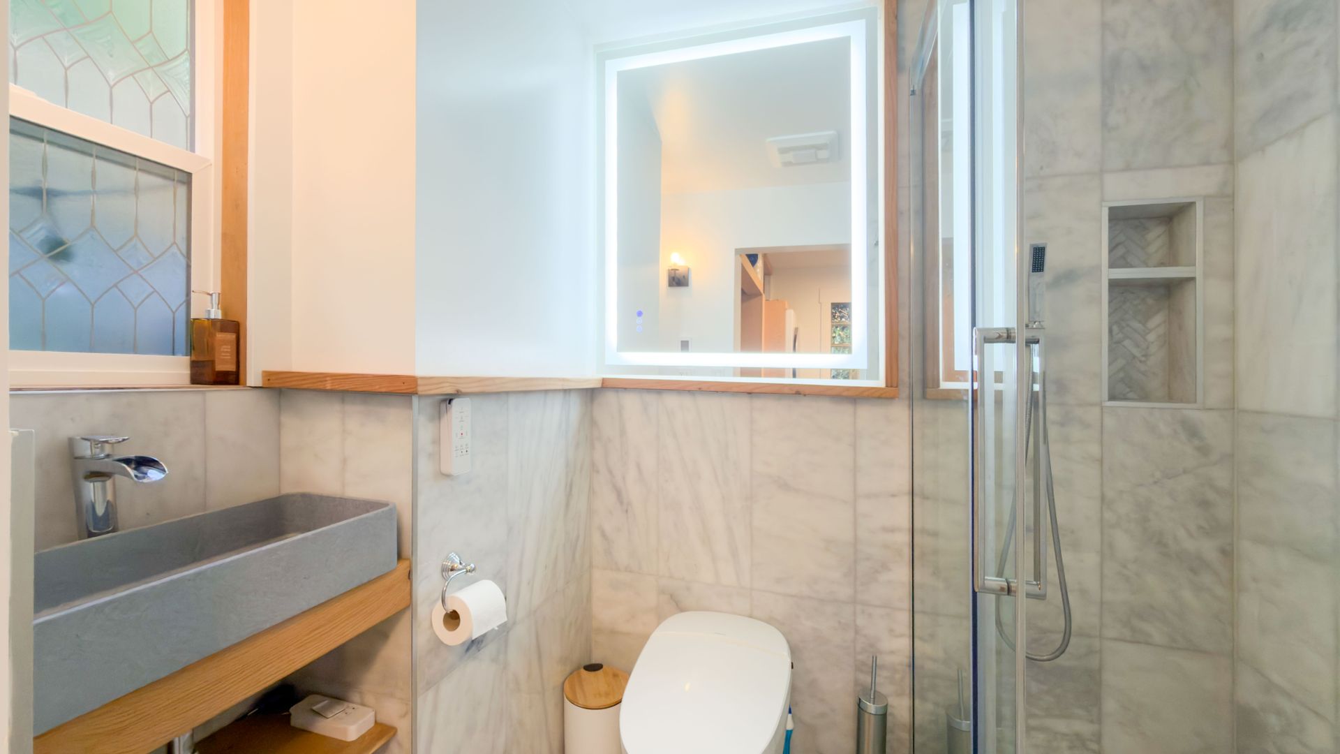 Bathroom featuring a marble finish shower and tile walls at 1709 Falcon Heights Road, Goldstream, Langford