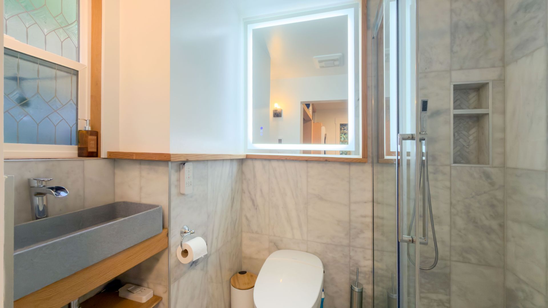 Bathroom featuring a marble finish shower and tile walls at 1709 Falcon Heights Road, Goldstream, Langford