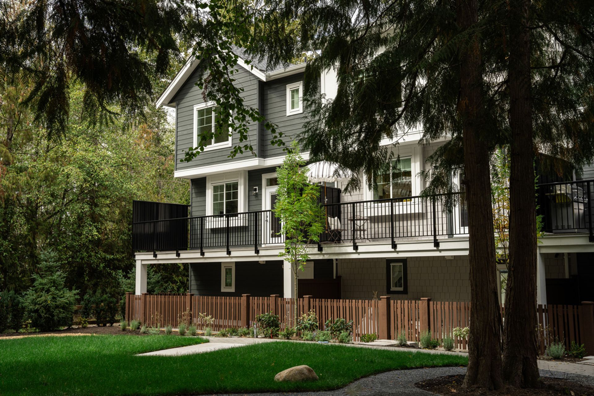 kinship-living-exterior-viewed-through-trees at 7919 204b Street, Willoughby Heights, Langley kinship-living-exterior-viewed-through-trees at 7919 204b Street, Willoughby Heights, Langley