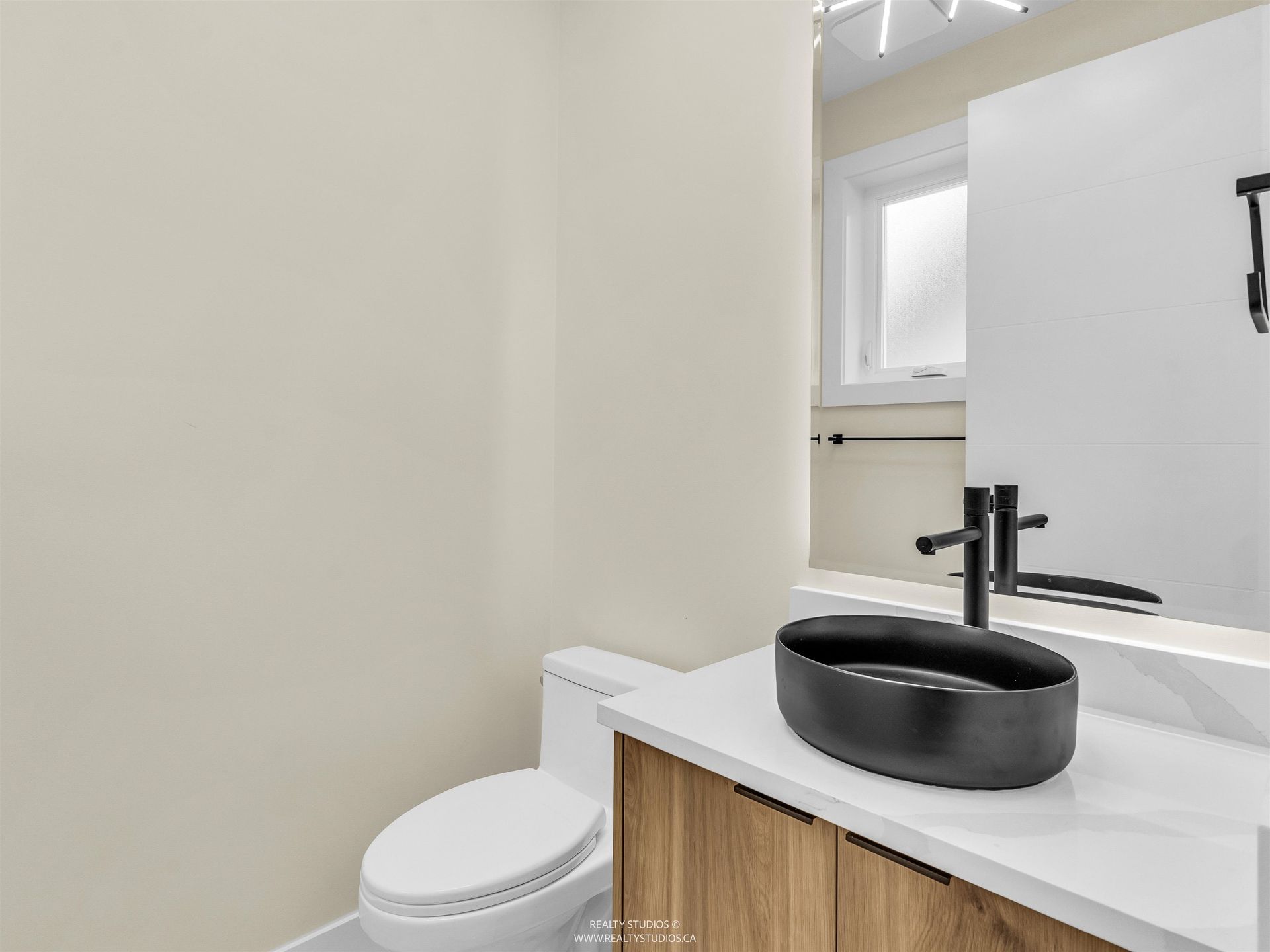 Main level powder room at 1 - 5221 Clarendon Street, Collingwood VE, Vancouver East Main level powder room at 1 - 5221 Clarendon Street, Collingwood VE, Vancouver East
