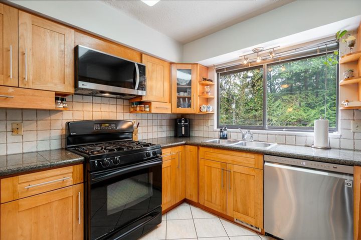 Bright North Vancouver kitchen with quartz counters and ample storage at 1184 Riverside Drive, Seymour NV, North Vancouver