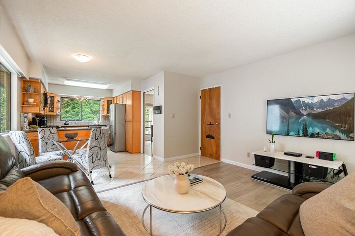 Dining area overlooking lush Riverside greenbelt and private backyard at 1184 Riverside Drive, Seymour NV, North Vancouver