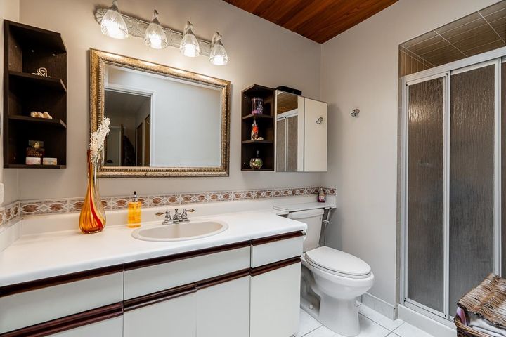 Luxury ensuite bathroom with spa-inspired design and vintage charm at 1184 Riverside Drive, Seymour NV, North Vancouver