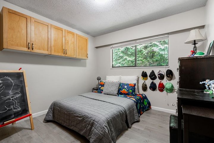 Cozy guest bedroom overlooking private Riverside setting at 1184 Riverside Drive, Seymour NV, North Vancouver