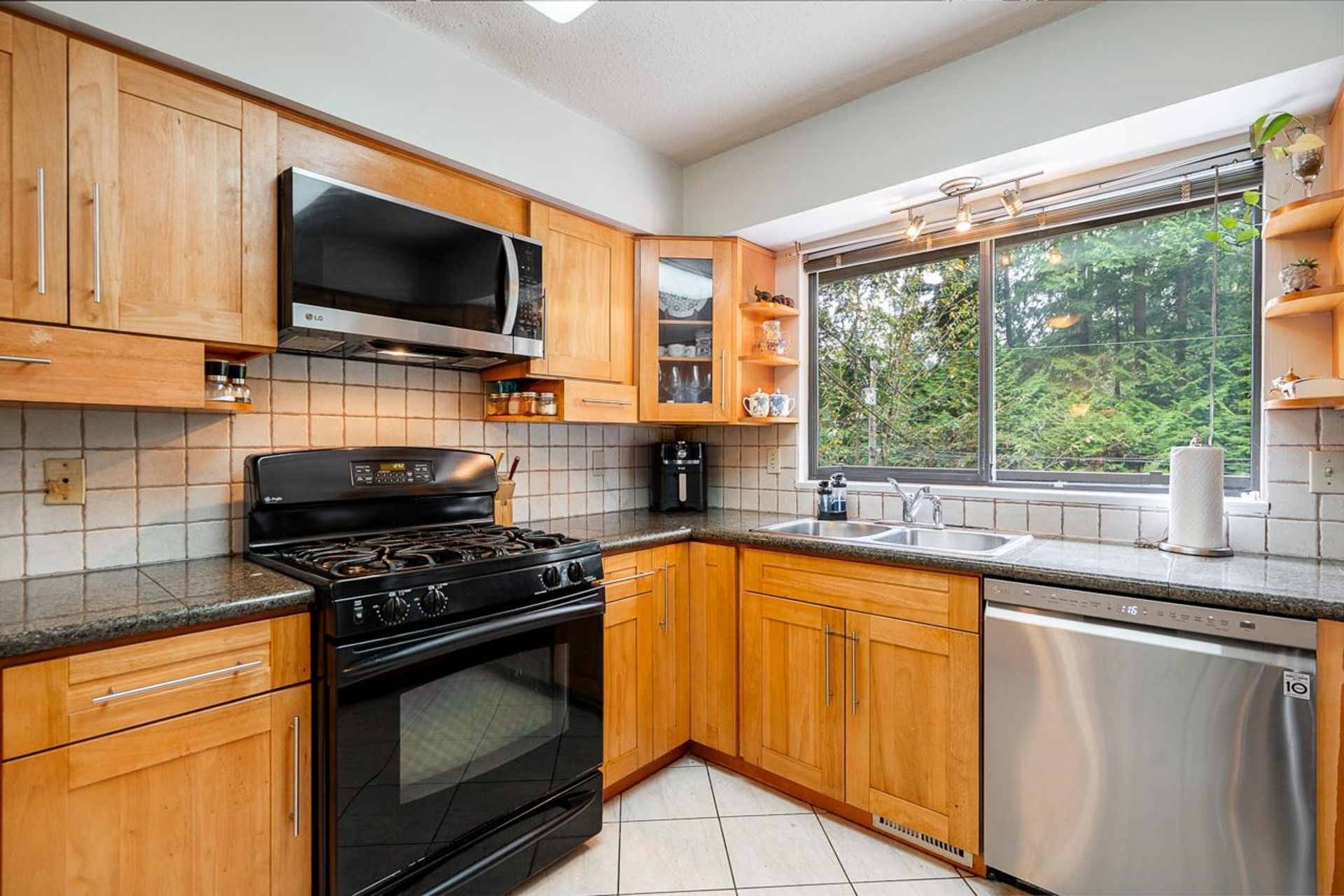 Bright North Vancouver kitchen with quartz counters and ample storage at 1184 Riverside Drive, Seymour NV, North Vancouver